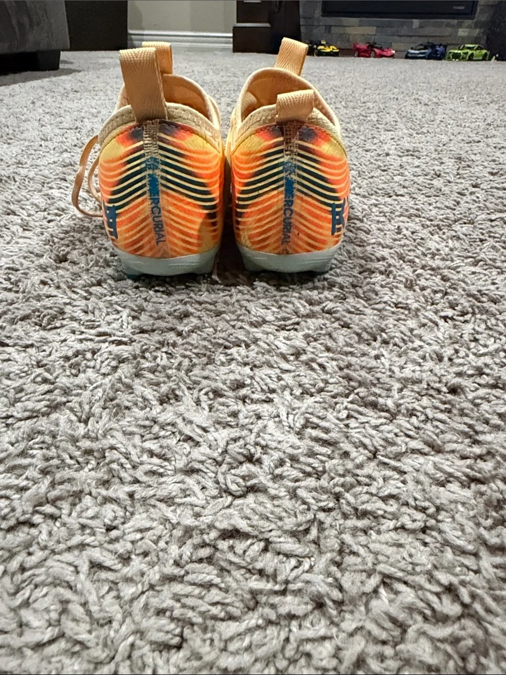 Nike Yellow Soccer Cleats with Blue Swoosh and Orange Accents